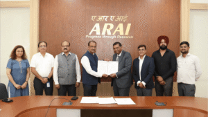 Eight people stand behind a desk before a wooden wall with a gold ARAI logo during a formal Indian certification.