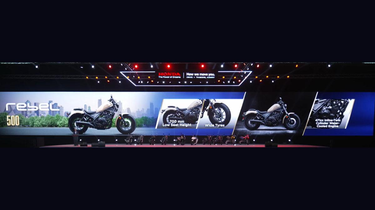 Presentation screen displaying a beige Honda Rebel 500 cruiser, 471cc twin engine close-up, and wide tyres feature.