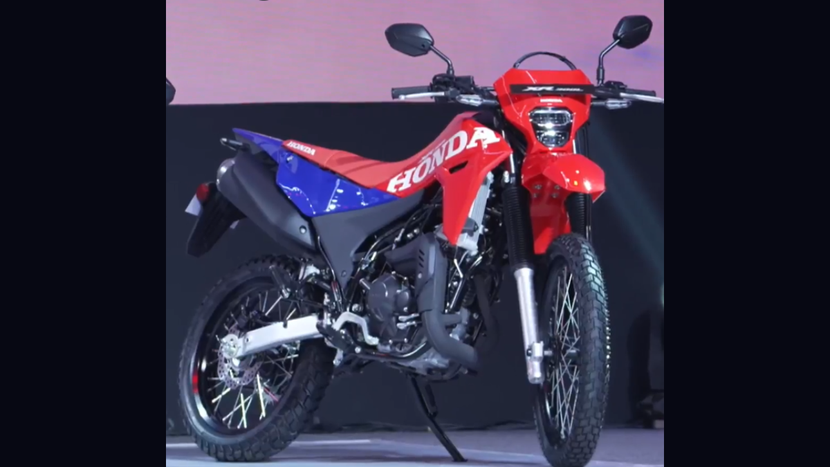 The lightweight trail bike made for rough Indian streets 1 Red and blue Honda XR300L dual-purpose motorcycle on display with spoked wheels and slim headlamp cowl.