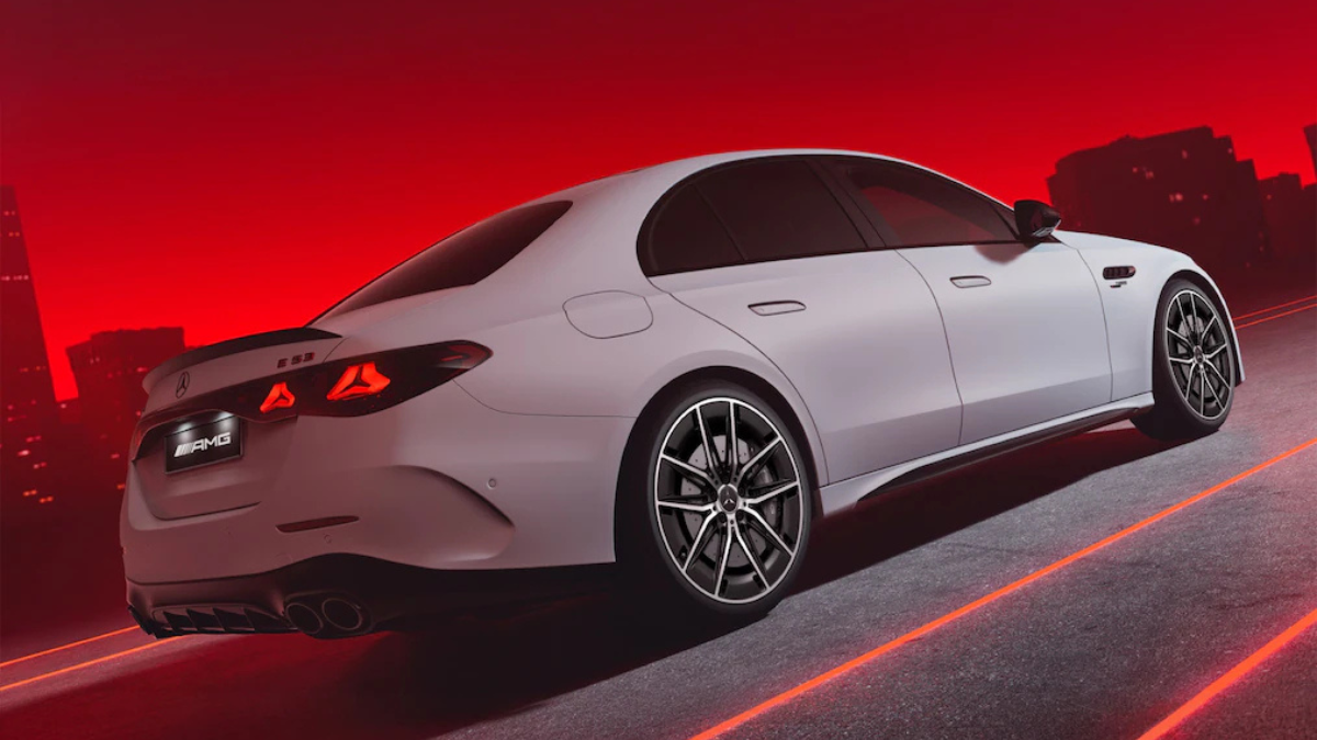 Light grey Mercedes-AMG E 53 sedan seen from rear showing star LED tail lights and quad exhaust outlets.
