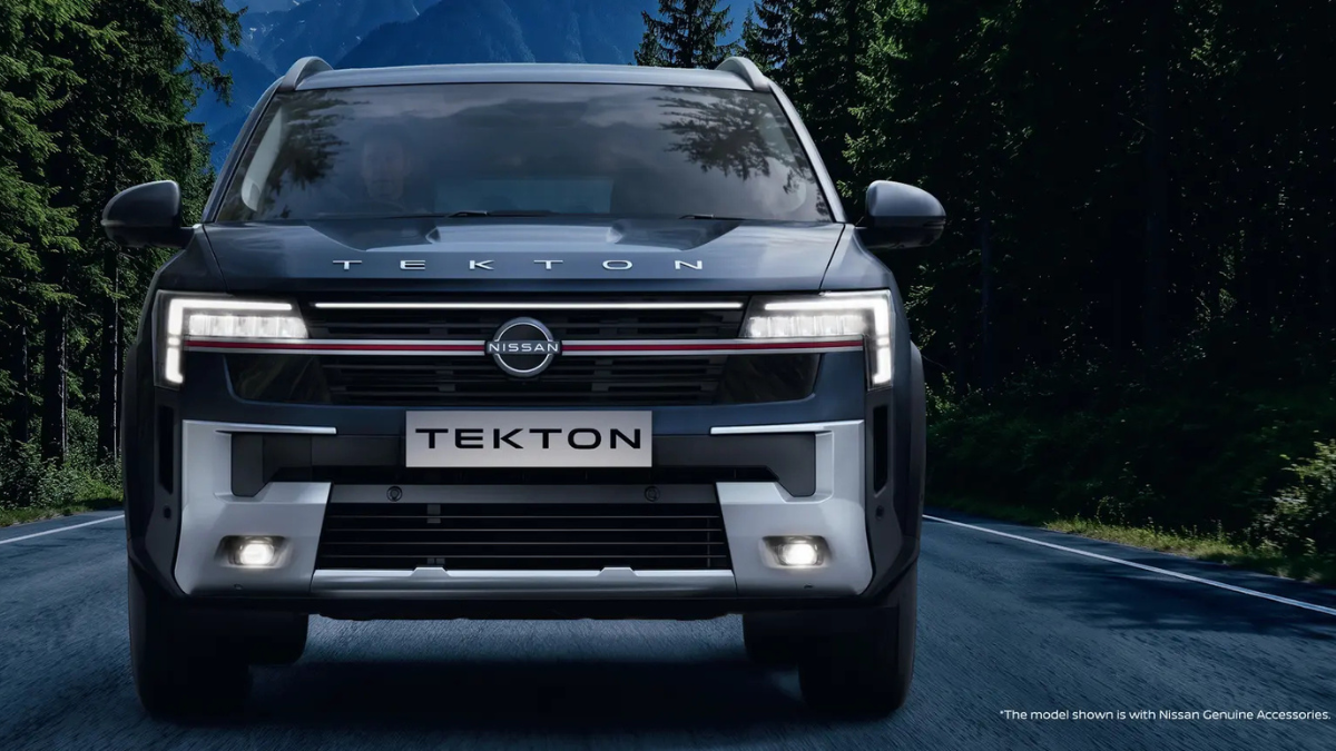 A 700 litre boot space sets a new standard for SUVs 2 Dark blue SUV front view driving on a road showing C-shaped LED headlamps and silver skid plate with green trees car.