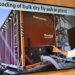 A large screen showing a red closed freight container, with Ashwini Vaishnaw pointing at the image in India.