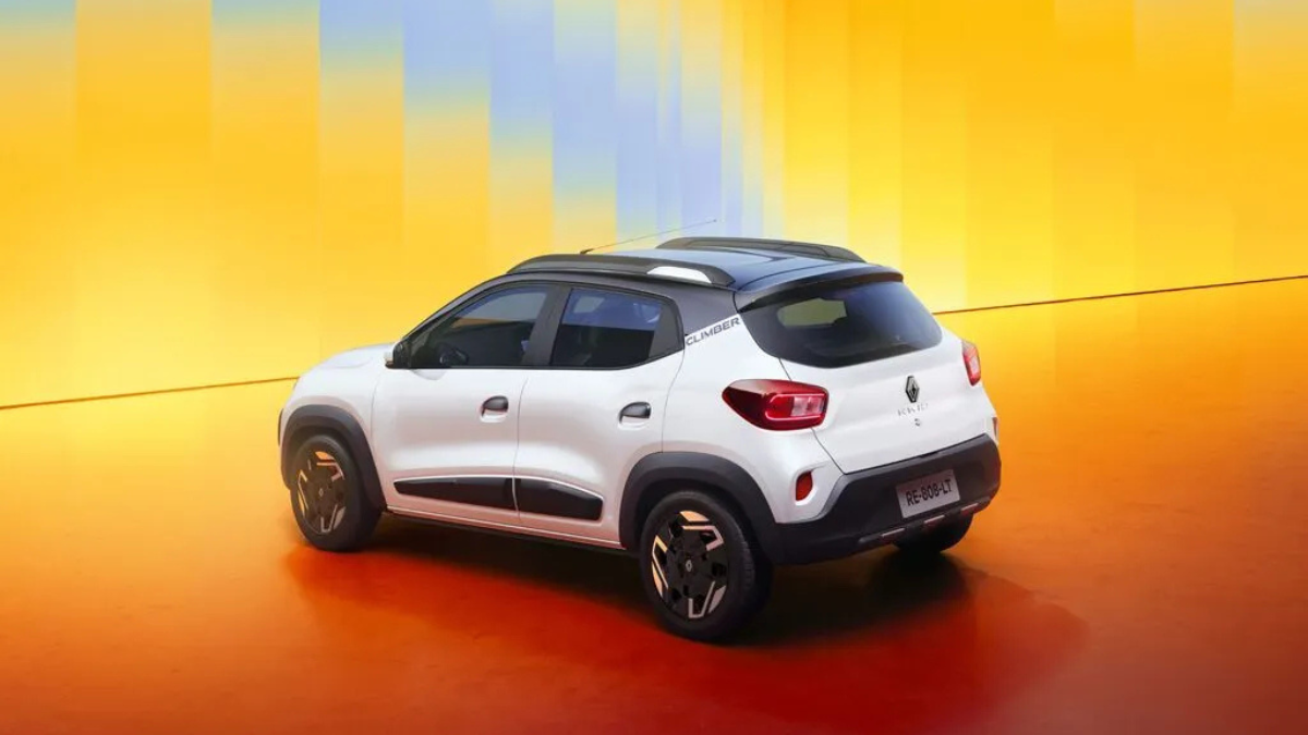 Six airbags and an 8-inch screen for under ₹6 lakh 2 White hatchback showing its rear side profile with Climber branding on the pillar against a yellow and orange backdrop.