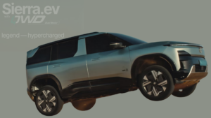 Silver electric SUV mid-air showing side profile and alloy wheels against a grey background with text.