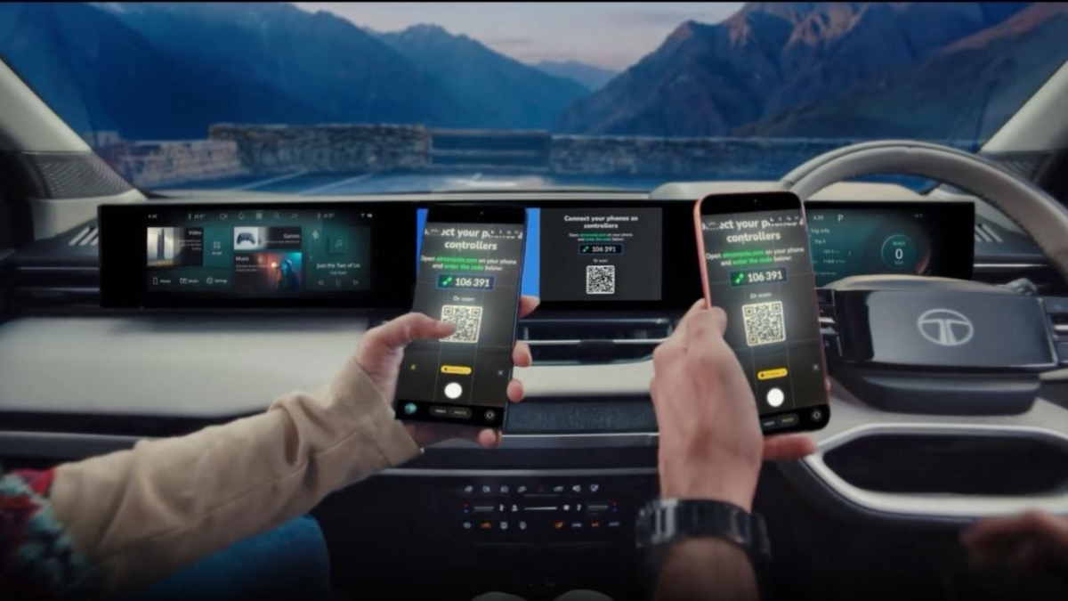 The electric vehicle feature worth exploring after the initial launch hype 1 Two occupants holding smartphones inside a Tata Sierra.ev scanning a central dashboard screen QR code for AirConsole.