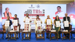 Officials standing on a stage holding TribeX posters in front of a National Workshop on Strengthening TRIs 2026 backdrop.