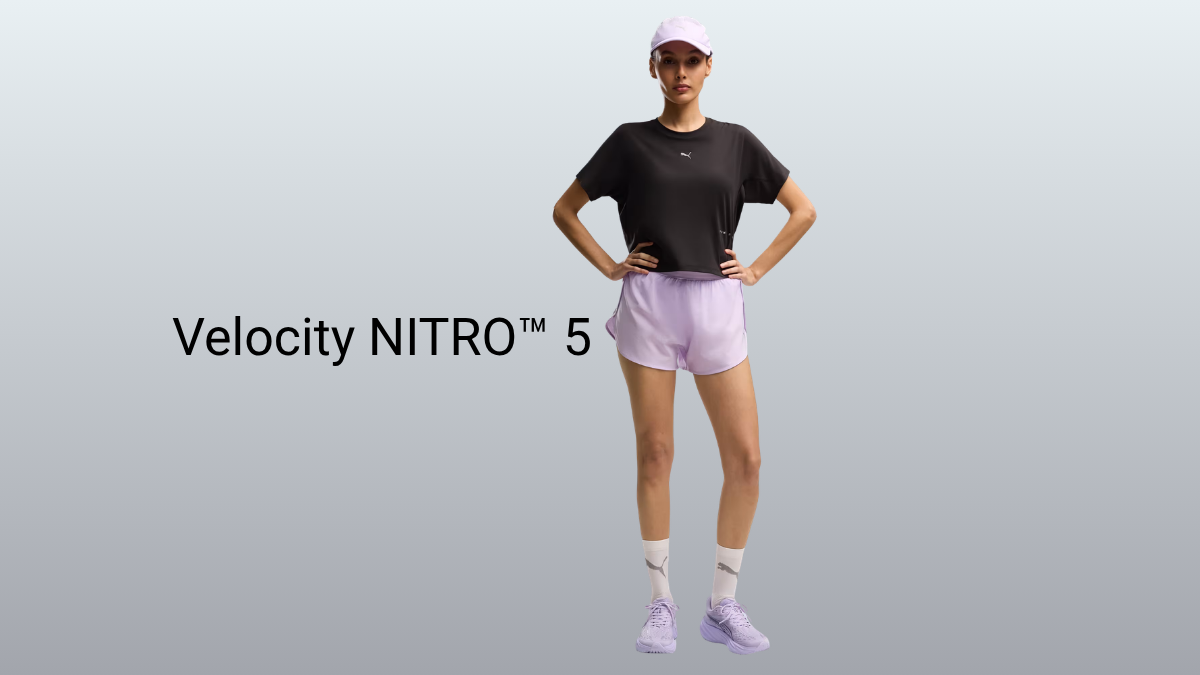 The wide-fit option that could end cramped toes for runners 1 A female model in a lavender cap, black top, and lavender shorts wears lavender PUMA running shoes against a grey backdrop.