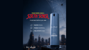 Text graphic, slate-blue bottle of in.skin Deep Hydration Gel on a wet ledge, city skyline and spider web skincare.