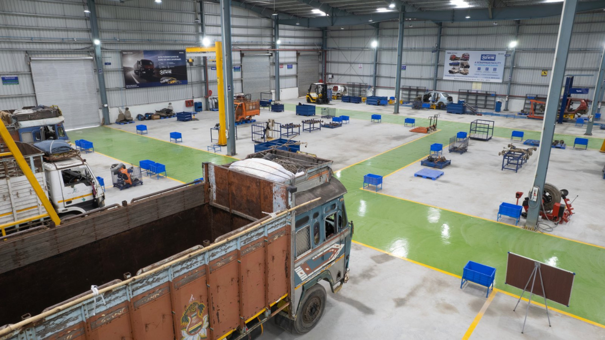 Patna gains a new vehicle dismantling centre as the network hits 12 1 An old truck parked on green floor paths inside a high-ceilinged industrial workshop with blue crates in Bihar.