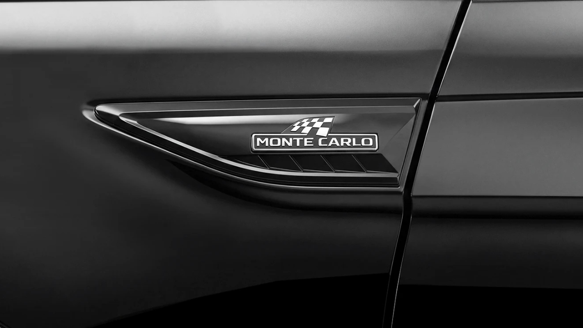 Sporty Slavia Monte Carlo gains illuminated front grille 1 Black car front wing featuring dark chrome garnish with checkered flag Monte Carlo lettering badge.