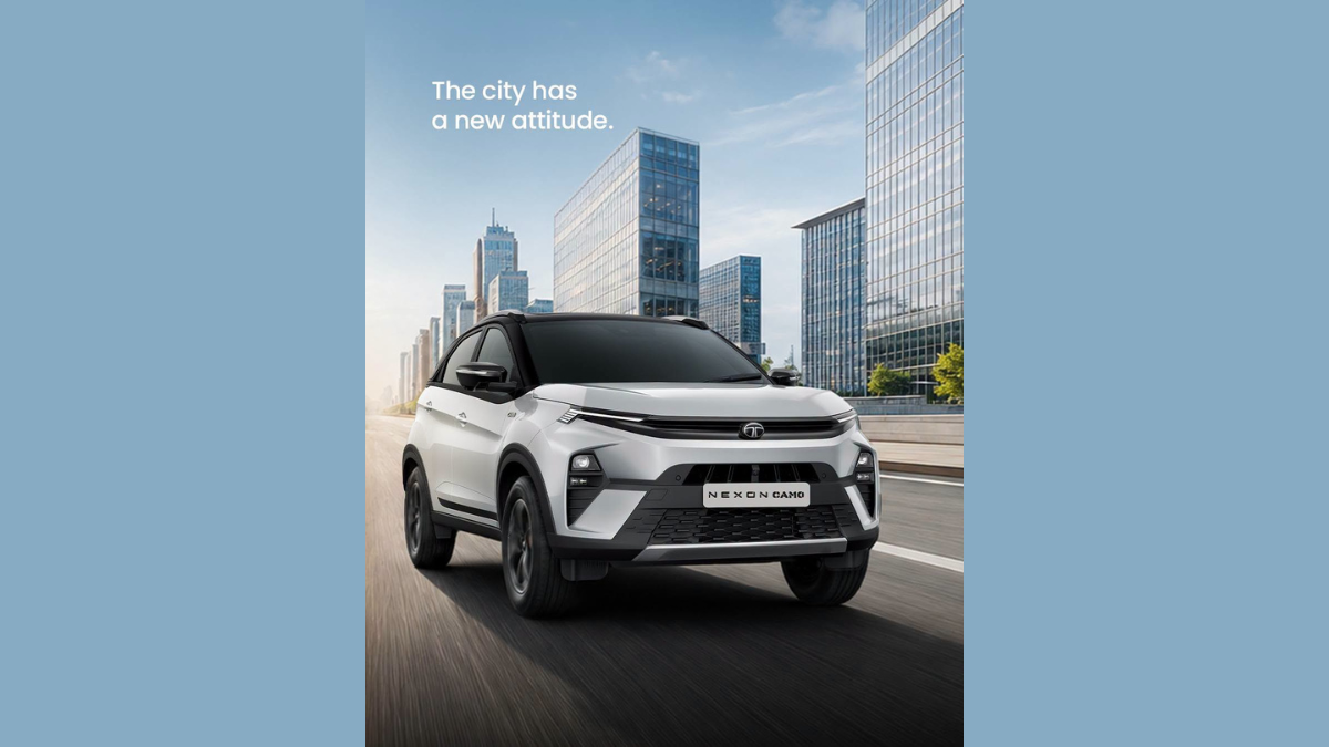 Fresh tech and styling upgrades hit the Nexon CAMO Edition from ₹9.99 lakh 2 Silver crossover driving on paved road, modern glass skyscrapers background vehicle.