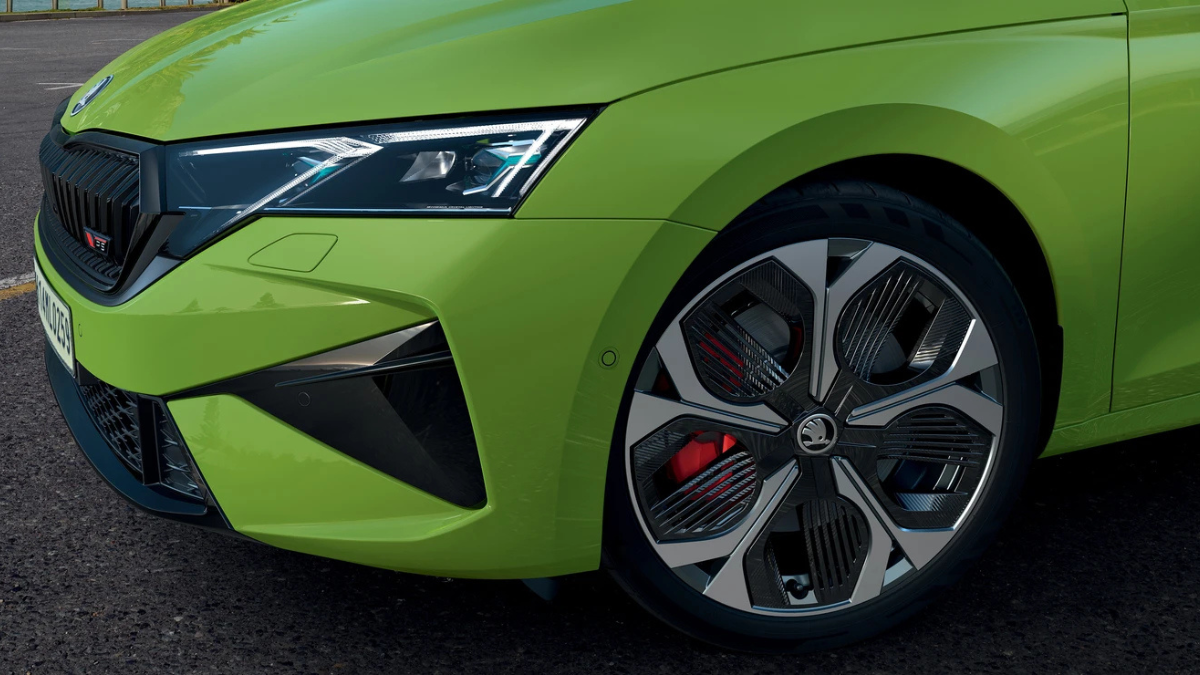 High-performance Octavia RS arrives with track hardware 1 Sharp led headlight, green front bumper, and aero-styled alloy wheel with red brake caliper on green car.