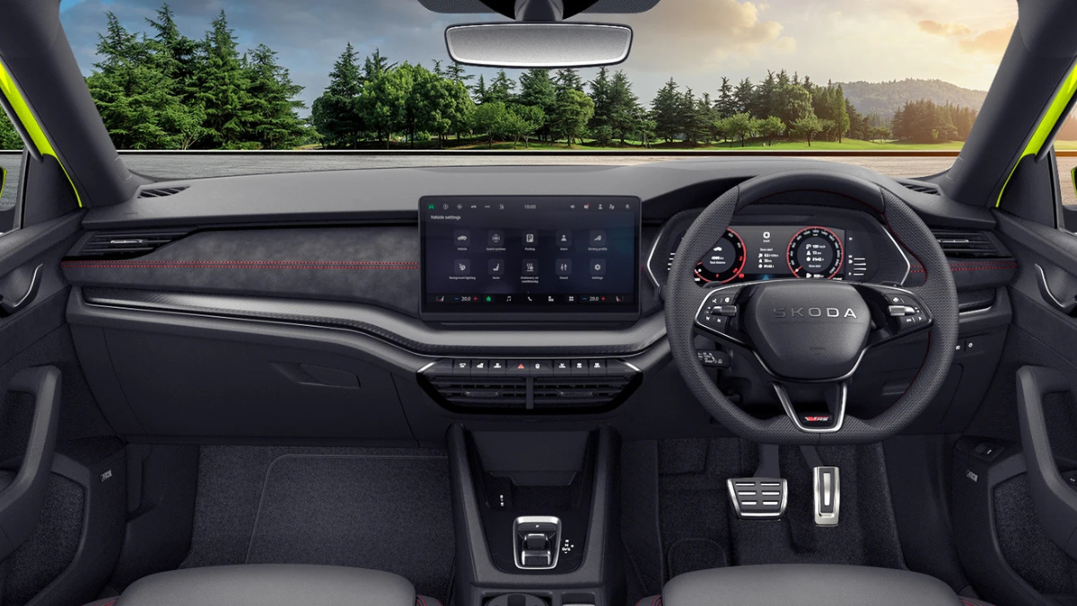 High-performance Octavia RS arrives with track hardware 2 Black three-spoke sports steering wheel, metal pedals, digital driver dials, and large central touchscreen cockpit.
