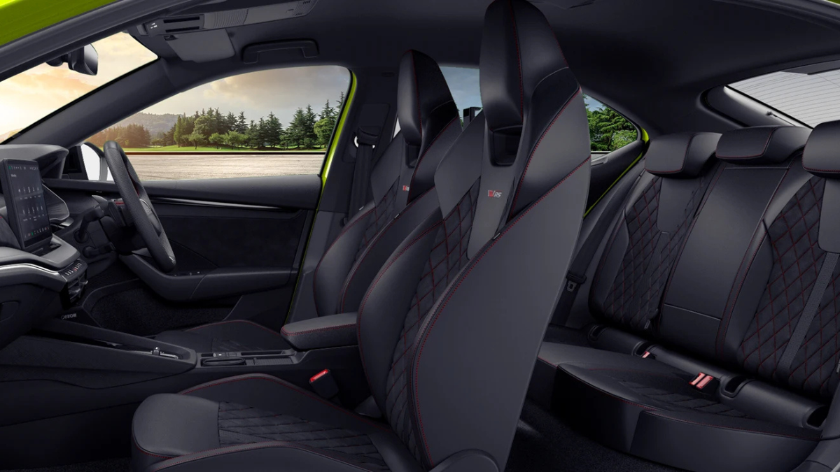 High-performance Octavia RS arrives with track hardware 3 Black sports bucket seats with integrated headrests, diamond red contrast stitching, and rear bench seating interior.