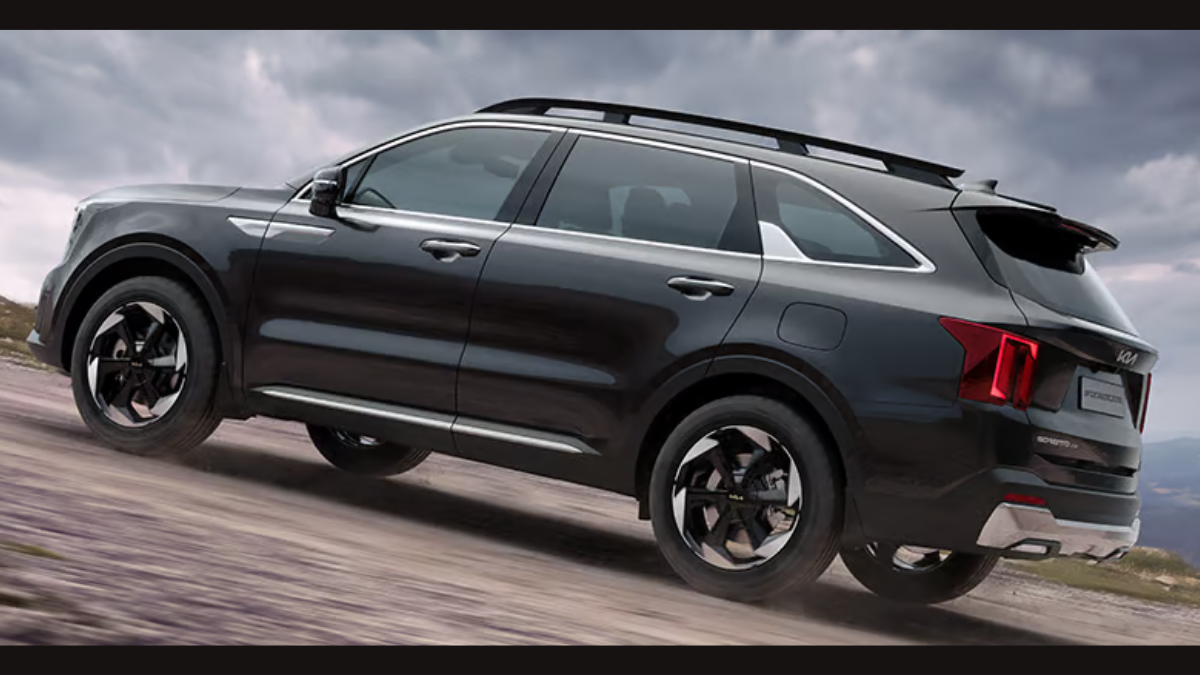 Hybrid Sorento brings segment-first AWD to India 3 Dual-tone alloy wheels on dirt track, dark SUV side panels, rear red taillights, silver skid plate, overcast sky exterior.