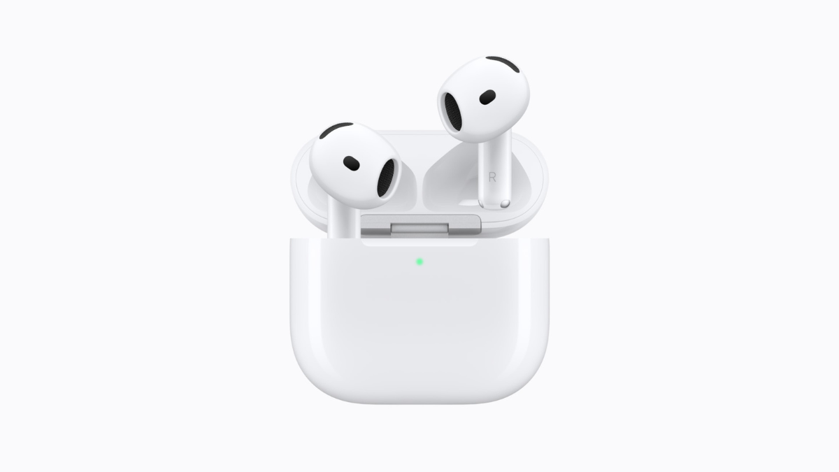Noise-cancelling open earbuds debut at ₹14,900 1 In the foreground, a white charging case holds the left and right AirPods 5 earbuds upright against a white background.