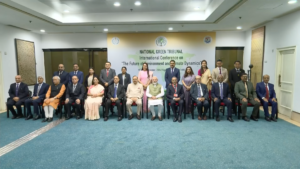 Delegates seated and standing before the International Conference on The Future of Environment and Climate Dynamics banner.