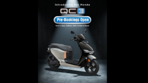 A pre-booking banner sits at top center above a grey and black Honda QC3 electric scooter on a dark studio floor.