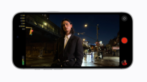 Left exposure readouts, person in black jacket on city street at night, Final Cut Camera record screen, display.