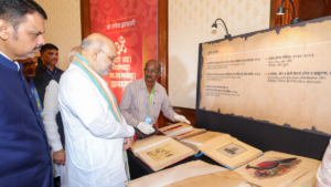 : Union Home Minister Amit Shah viewing rare manuscripts and open books at the Ganesh Gyanarthi Exhibition in Mumbai.