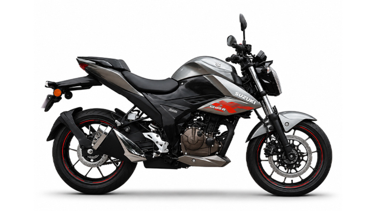 Fresh dual-tone shades arrive across updated Gixxer series 1 A grey and black naked motorcycle stands facing right against white, with rear wheel on left and handlebar on right.