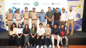 Eight seated winners in the foreground, with police officers standing behind against a Gridlock Hackathon 2.0 backdrop.