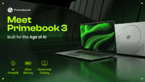 Green text beside an open Primebook 3 laptop showing an abstract display in front of dark geometric panels setup.