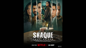 Left to right, torn cast portraits line the background, with a cake and the Shaque title sitting in the foreground.