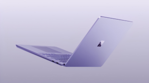Surface Laptop 13-inch keyboard and ports angled toward raised display lid with four-square logo studio.