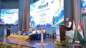Dignitaries on stage beside podium speaker and Defence Research and Development Organisation VIMARSH backdrop event.