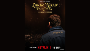 A man in a dark jacket faces away in the foreground toward a stage, beneath Papa Yaar title text at the top.