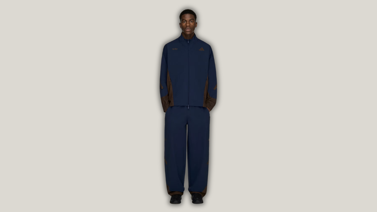 90s football nostalgia arrives with ₹13,999 mixed material trackpants 1 In the centre against a grey backdrop, a man stands facing forward wearing the Z.N.E. Material Mix Trackpant and jacket.