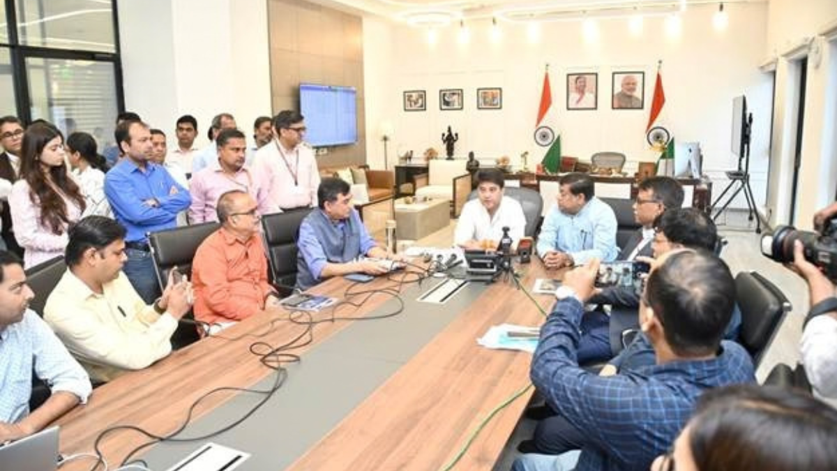 Northeast food series trailer arrives without release date 1 Foreground journalists taking photos of seated ministry officials at a wooden table with Indian flags in a conference room.